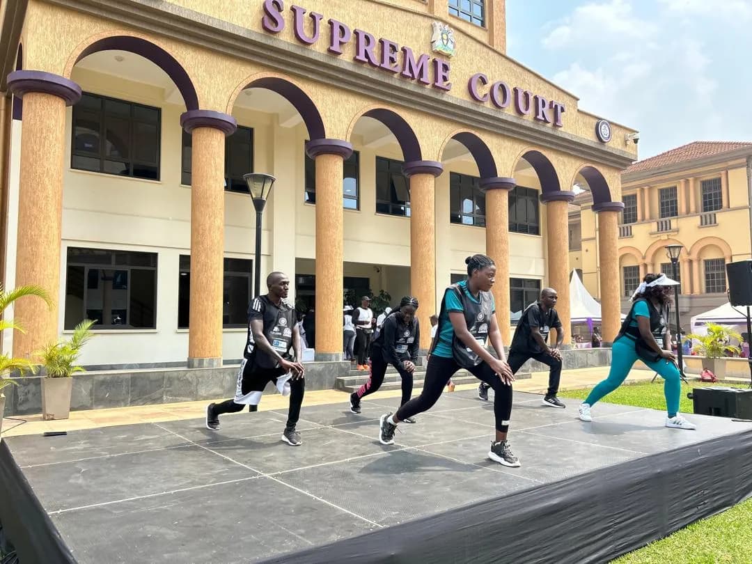 Judicial officers taking part in a Bob Mazoezi movement session outside the Supreme Court of Uganda during the UJOA Wellness Day