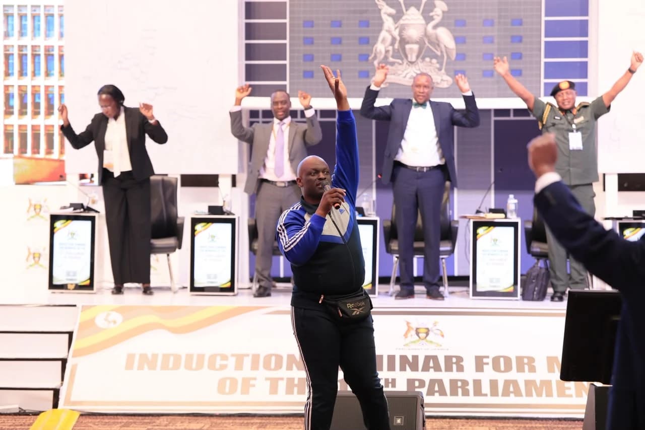 Coach Bob Ssebugwawo leading a movement session for Members of Parliament at a Parliament of Uganda induction seminar